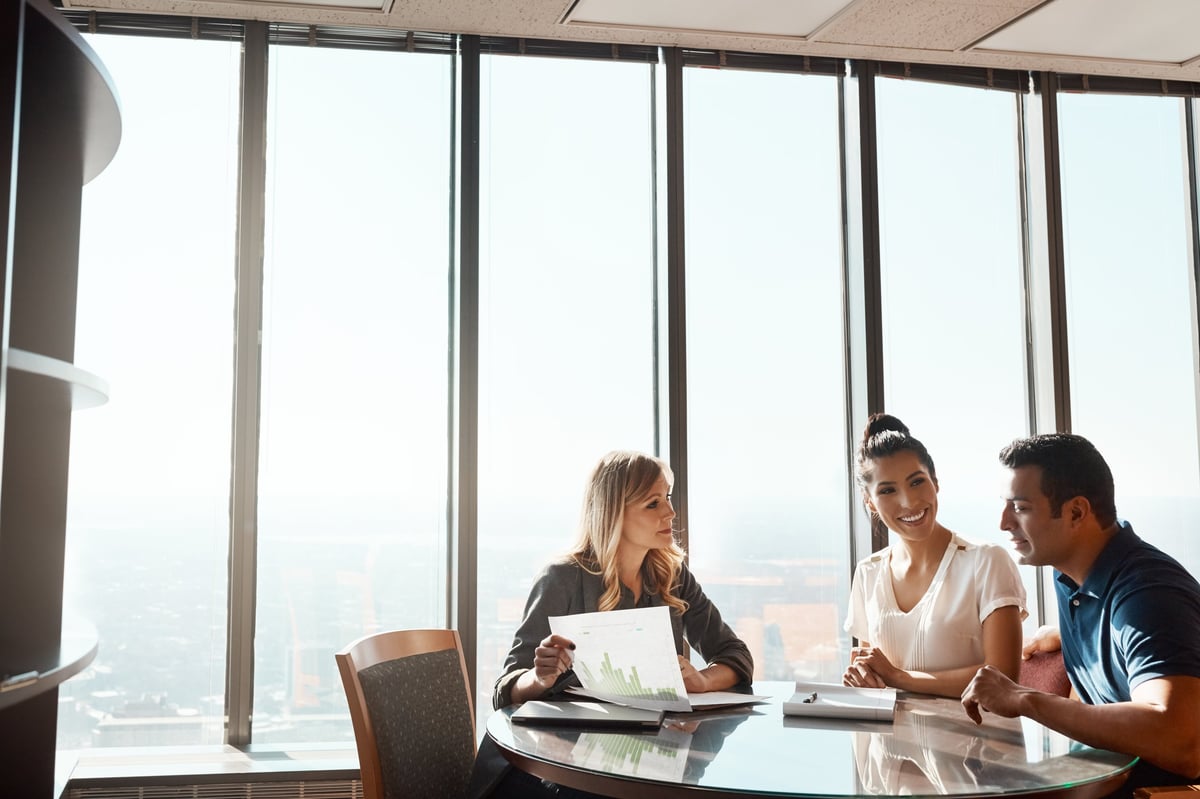 A couple meeting with a financial planner in a bright modern office